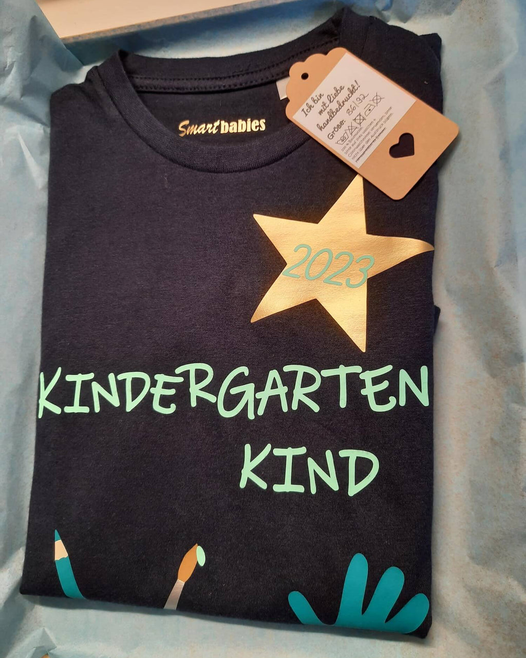 Verpackung mit Etikett von navi Kindergartenshirt Kindergartenkind mit Name und Jahreszahl für KITA-Anfang, kurze Ärmel