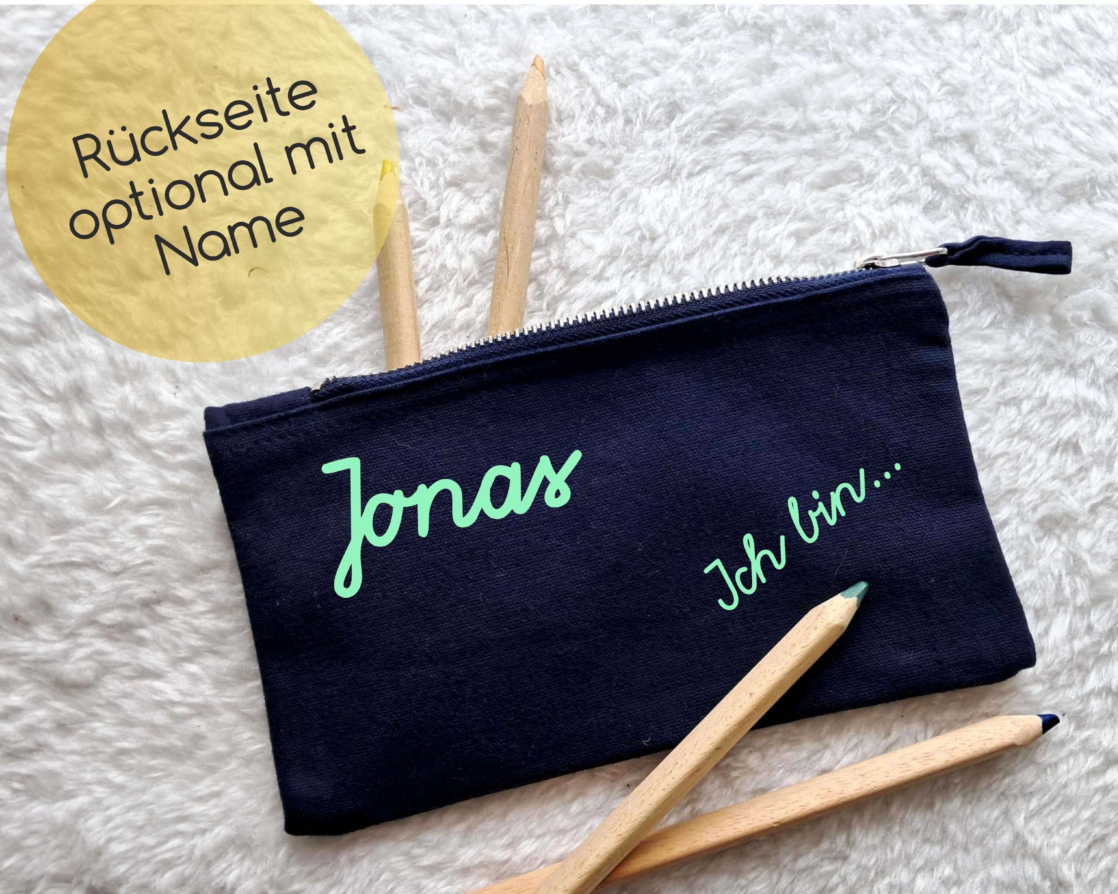 Rückseite navi Stiftemäppchen mit Reißverschluss, bedruckt mit Ich bin 1. Klasse in Schreibschrift und gold metallic Stern und Name