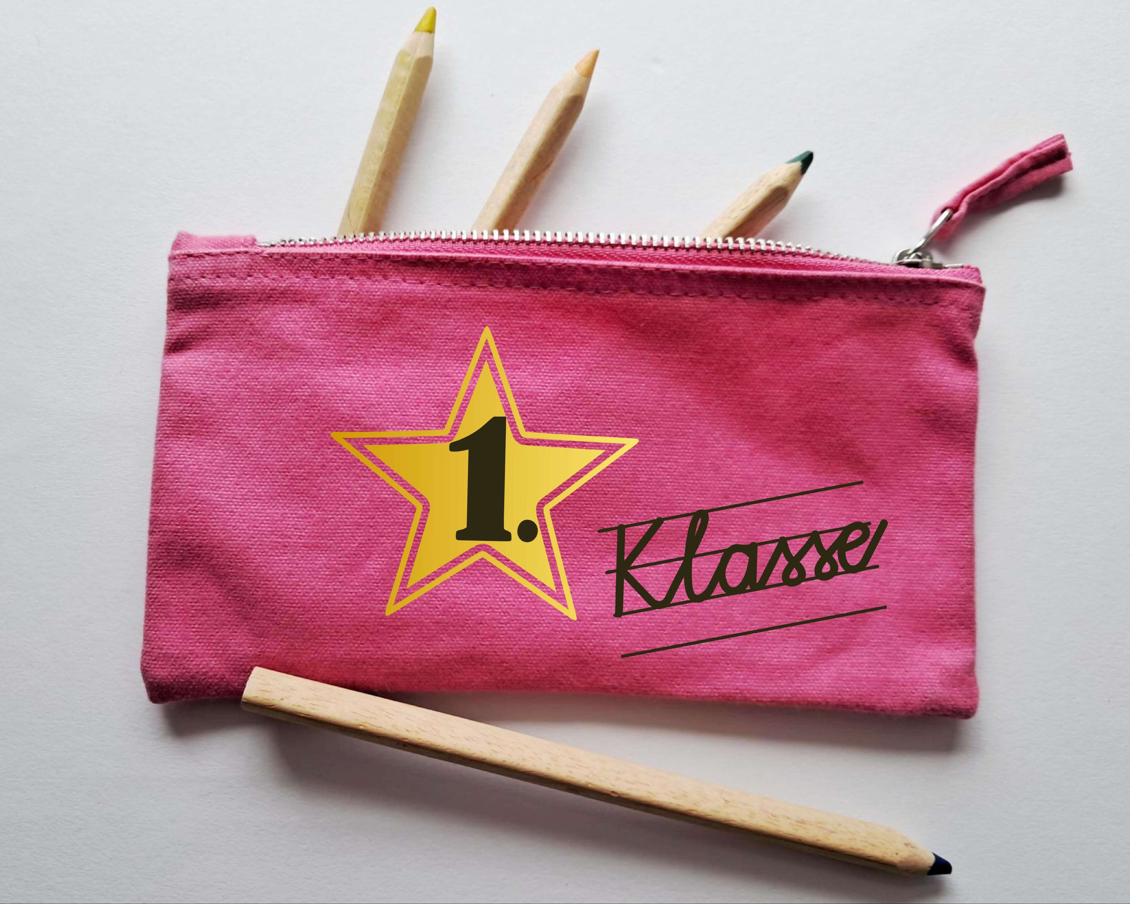 pinkes Stiftemäppchen mit Reißverschluss, bedruckt mit 1. Klasse in Schreibschrift und gold metallic Stern