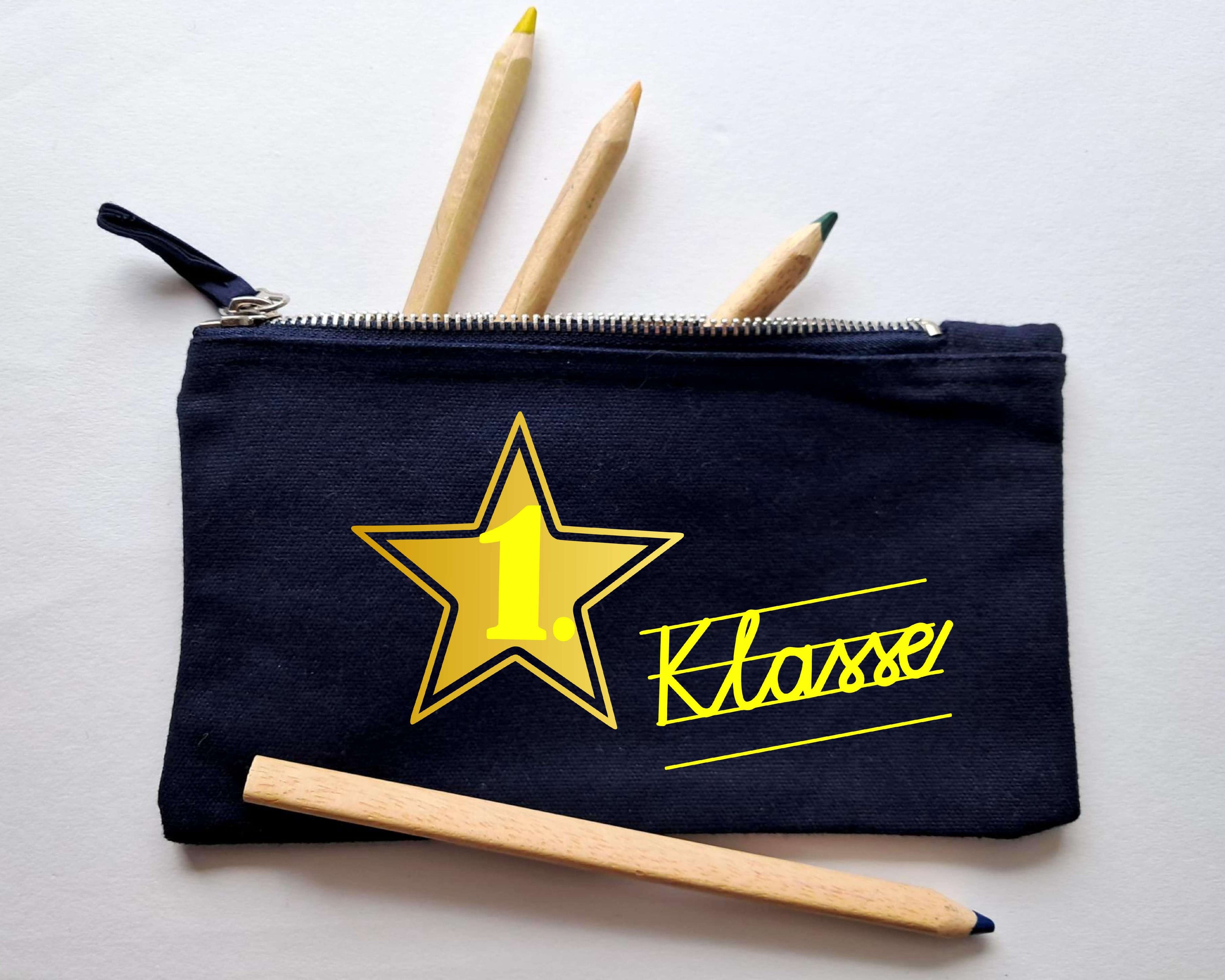 navi Stiftemäppchen mit Reißverschluss, bedruckt mit 1. Klasse in Schreibschrift in gelb und gold metallic Stern