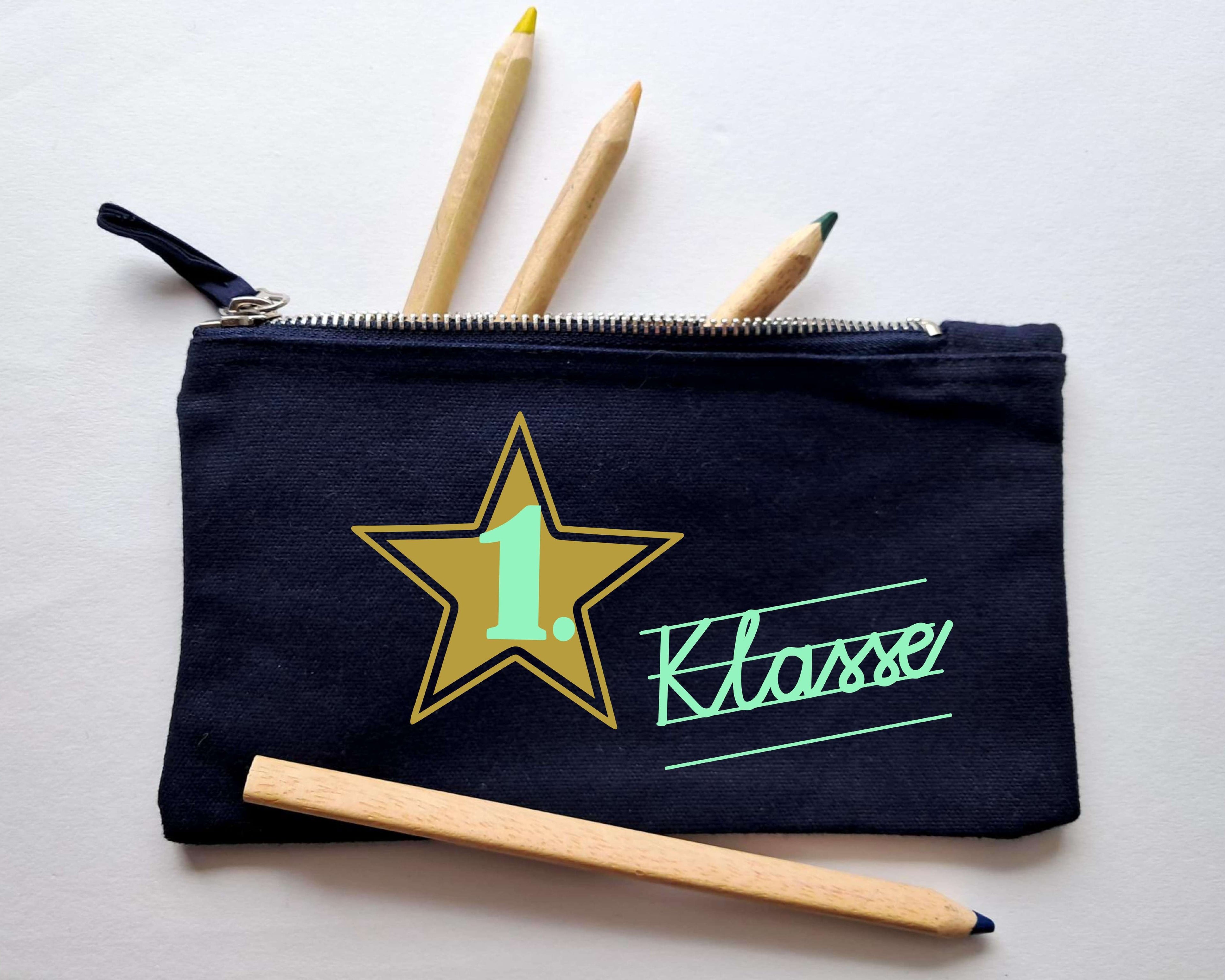 navi Stiftemäppchen mit Reißverschluss, bedruckt mit 1. Klasse in Schreibschrift und gold metallic Stern